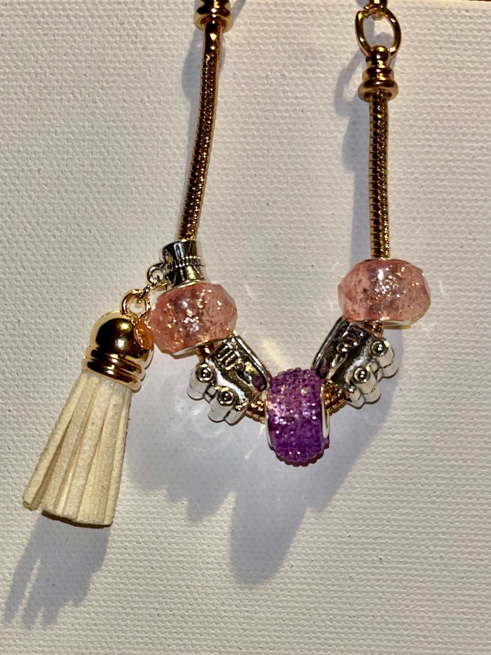 Gold-Tone Snake Chain Bracelet w/Pink & Purple Beads, Cream Tassel & Train Charm